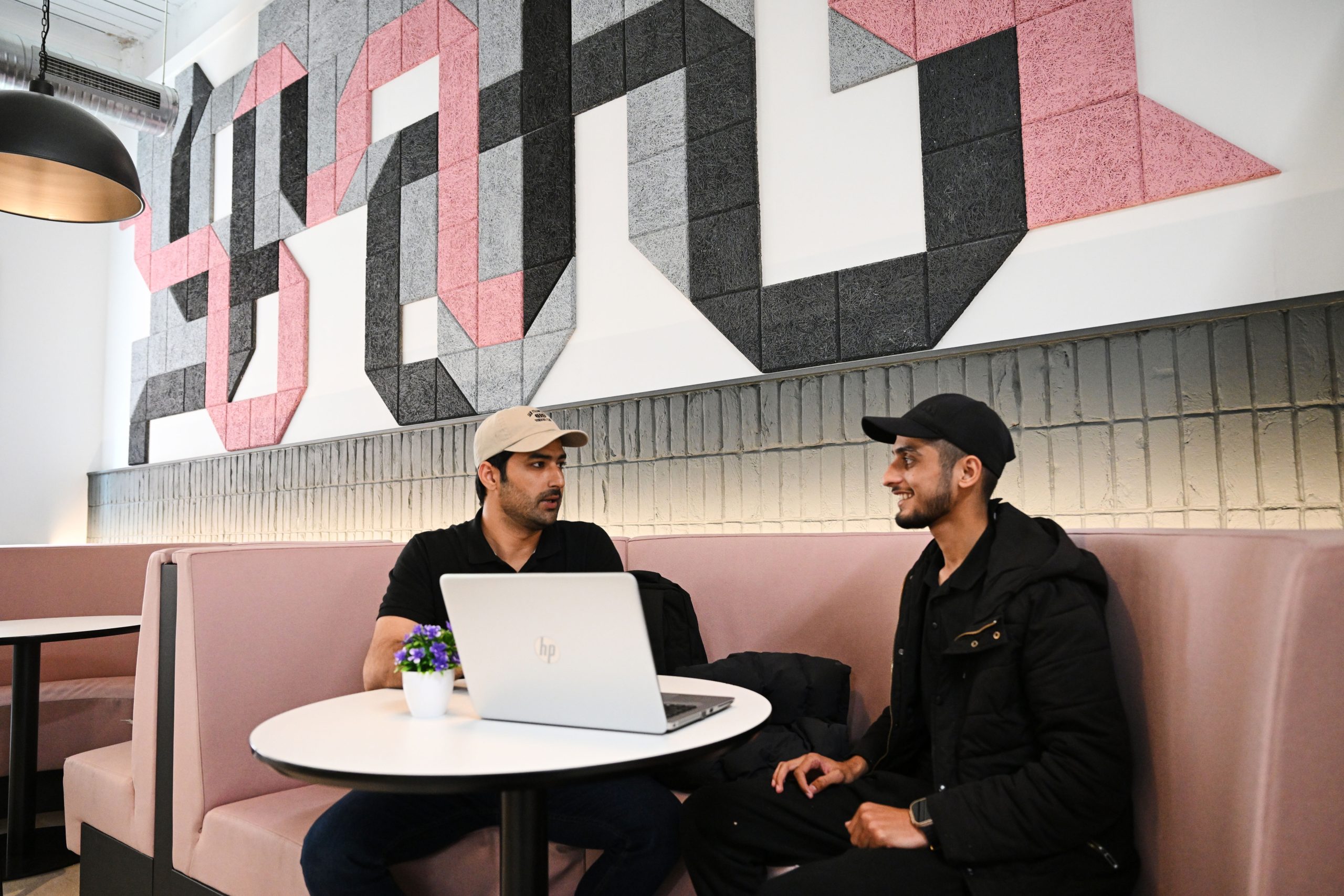 two students sat in the breakout area of the Birmingham campus